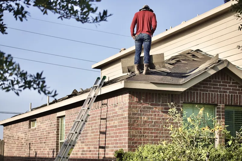 Professional roofer working on a residential roof in Downtown Boston